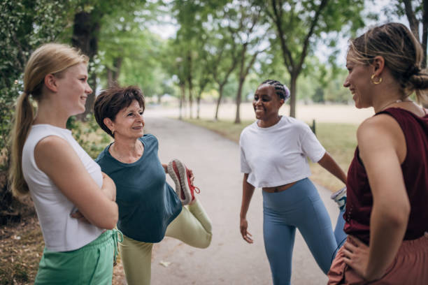 istock Women exercising together in park 1422605839