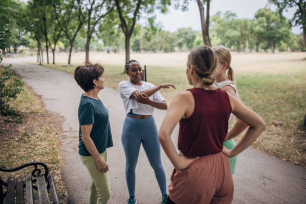 istock Women exercising together in park 1422606085