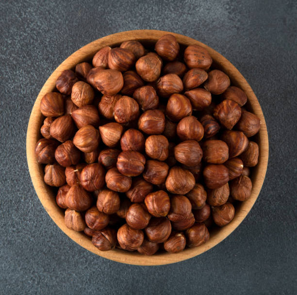 istock Bowl full of hazelnuts  on dark background 1422610395