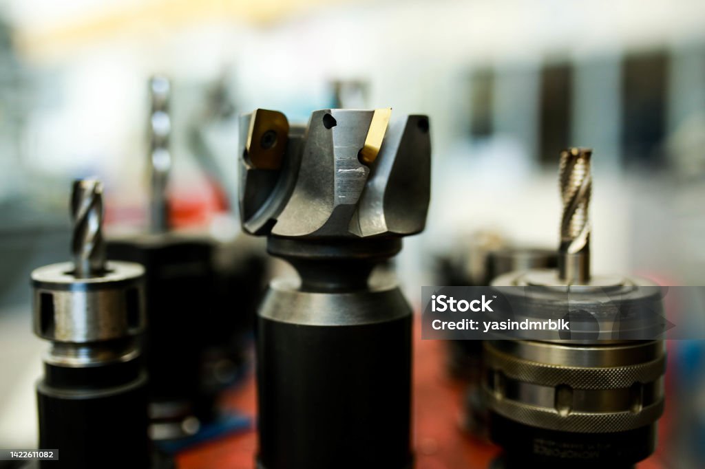 cutting tools used in cnc milling machine.  face milling with insert, end mill mounted in tool holder Accuracy Stock Photo