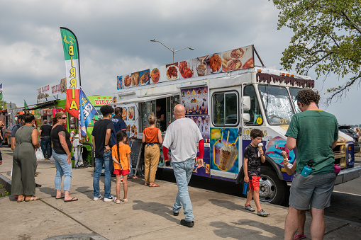 New Haven, CT, US-September 6, 2022: People line up for Mexican and Latin American food at food trucks Food Truck Paradise area.