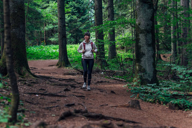 istock Young woman hiking through the forest 1422614169