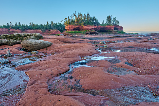 Setting sun lights up the tidal pools and seastacks at Burntcoat Head in Nova Scotia at low tide.  This are is know for the highest tides in the world.