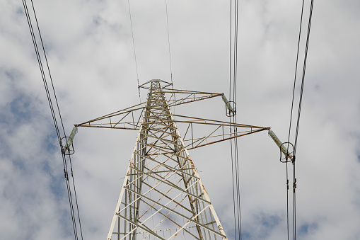 High Voltage Transformer for delivery energy, cloudscape on the blue sky, from bottom to top