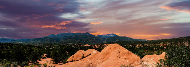Panoramic landscape view from the Garden of the Gods park looking towards the west and Pikes Peak at the spectacular sunset. stock photo