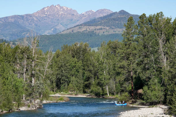 istock Fishing raft on river with mountains in background 1422621292