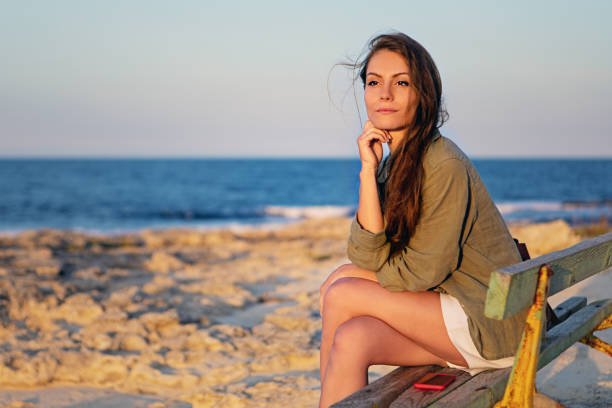 Windy day at the seaside - Woman embracing nature - Zen-like portrait