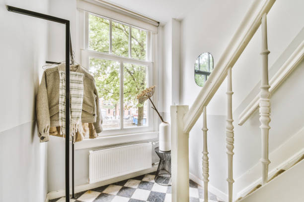istock Staircase with white steps infront of a bright window 1422640144