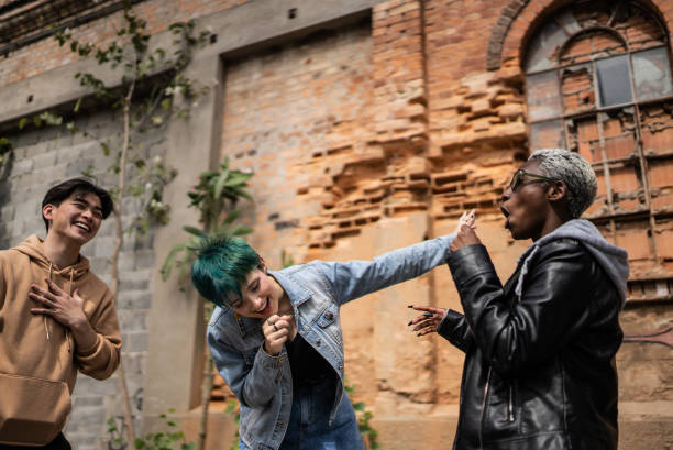 Young man with dreadlocks is admiring graffiti he had drawn