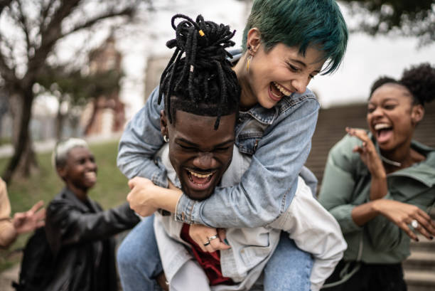 istock Friends playing piggyback outdoors 1422644044
