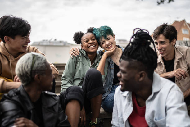 Friends talking in the street Friends talking in the street adolescents hanging out stock pictures, royalty-free photos & images