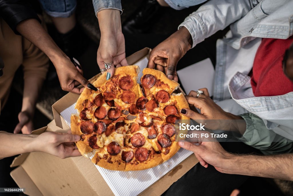 Hands picking pizza slices Pizza Stock Photo