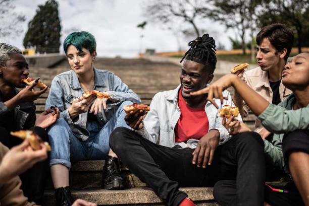 istock Friends eating pizza in the park 1422644317