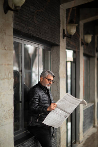 istock Business man reading newspaper in Nyc 1422648186