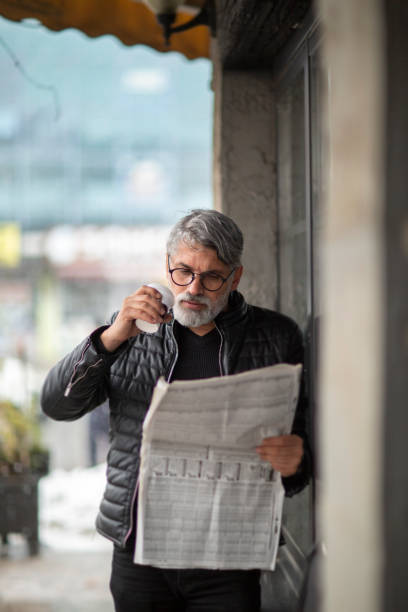 istock Business man reading newspaper in Nyc 1422648270