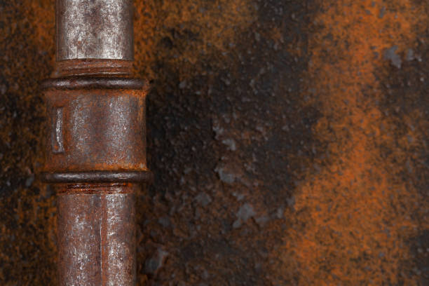 Old rusty valve pipes on rusty metal wall background