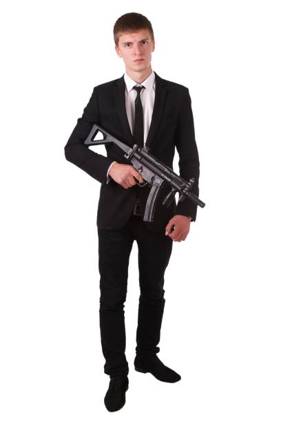 istock man in black costume with submachine gun (SMG) 1422649439