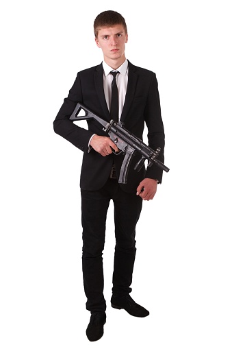 man in black costume with submachine gun (SMG) isolated on white background