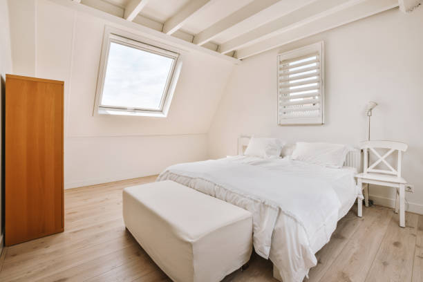 istock A small cozy bedroom with a white bed under a trapezoidal roof 1422650606