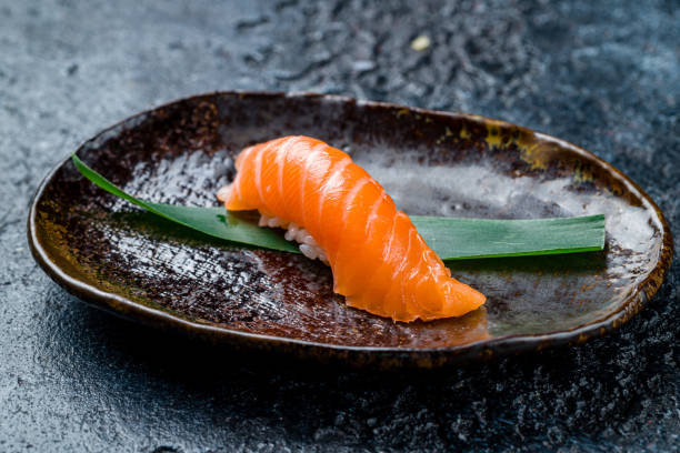 istock sushi salmon on a plate on dark stone table 1422650791