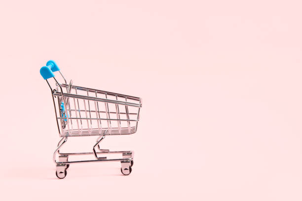 istock Empty shopping cart with light blue details on a pastel pink background. 1422651738