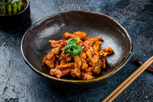 istock chicken in sweet and sour sauce on dark stone table 1422652308
