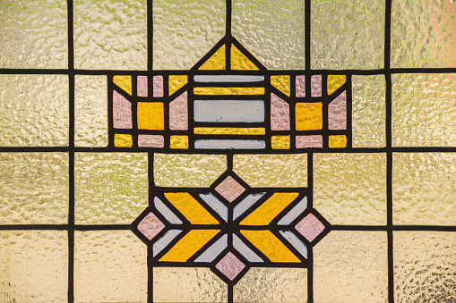 Stained glass window with matte design close-up in a cozy house