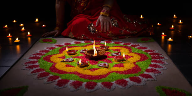 istock Happy Diwali - Diya lamps lit during diwali celebration 1422662797