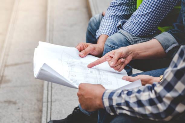 istock Civil engineer teams meeting working together wear worker helmets hardhat on construction site in modern city. Foreman industry project manager engineer teamwork. Asian industry professional team 1422666108