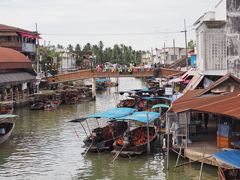 Mae Klong River, Amphawa Market, silver-gray white, turquoise sky and gray-white light clouds, yes as a background.