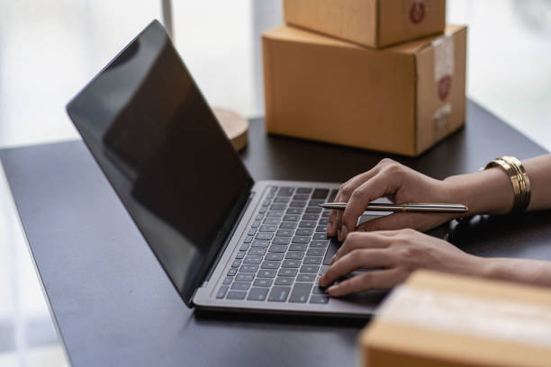 istock online store small business owner, seller, e-commerce boxing, checking website retail order using laptop preparing parcels for delivery sme business ideas 1422680335
