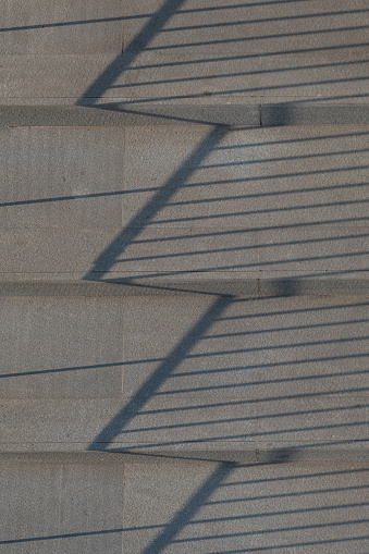 Reflection of railings on the concrete floor