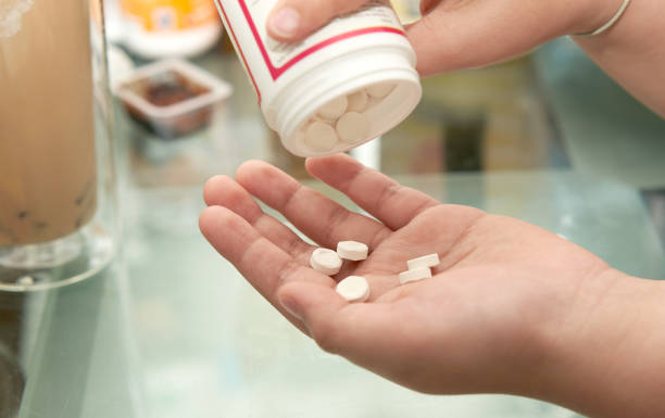istock kid pour pills into palm hand 1422700473