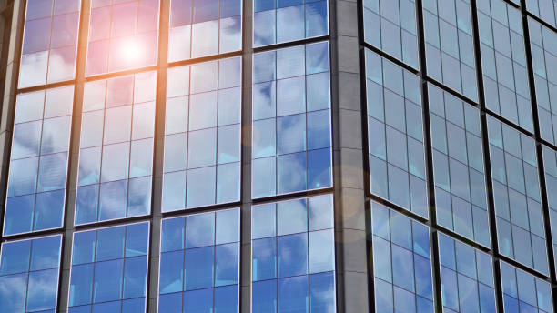istock Modern glass facade against blue sky. 1422704018