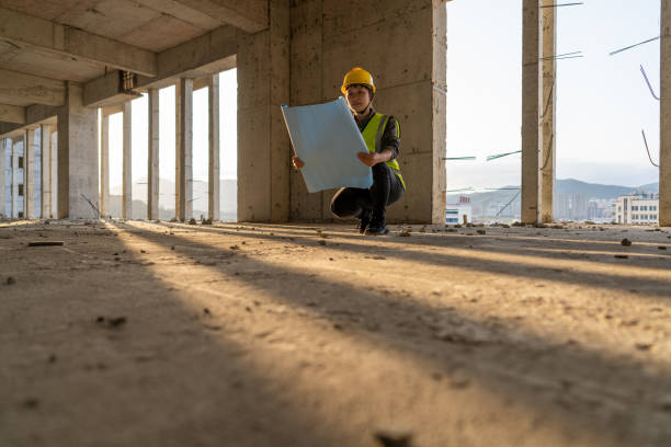 istock An Asian woman construction worker is checking construction drawings on the construction site 1422707692