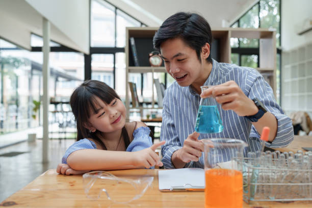 istock Kid and teacher doing science experiments. back to school concept 1422709252