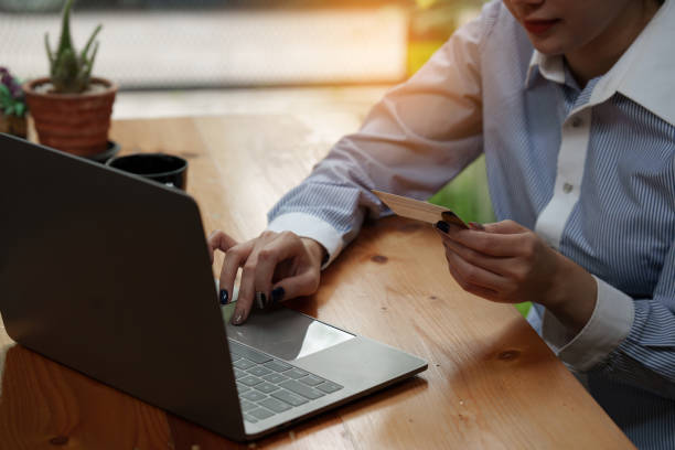 istock Young person using credit card and laptop computer. Online shopping, e-commerce concept 1422709832