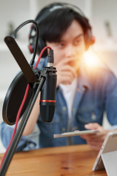 istock Asian podcaster making audio podcast working with guest at home studio 1422712176