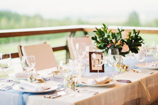 Beautiful floral arrangements used as table decorations at a wedding ceremony. The image captures the romantic and festive atmosphere of a wedding, featuring carefully arranged flowers that add elegance and charm to the celebration. Perfect for themes related to weddings, event planning, floral design, and special occasions.