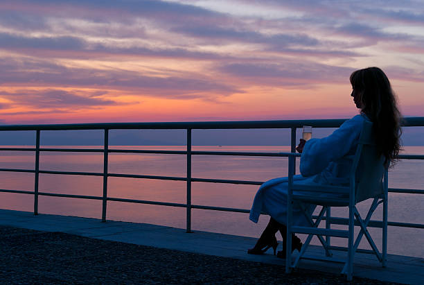 istock Woman watching the mythical colorful sunset 142272051
