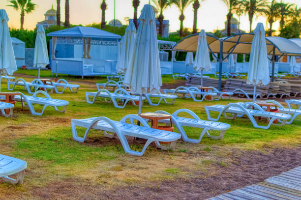 istock Empty beach with sun beds and sun shades during summer morning. 1422722034