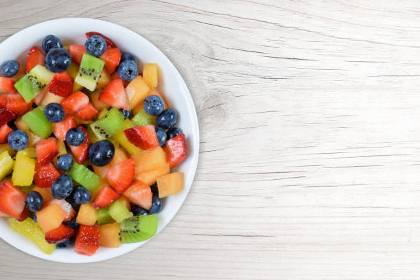istock Fresh Cut Fruit Salad on White Wood Background with Copy Space 1422722642