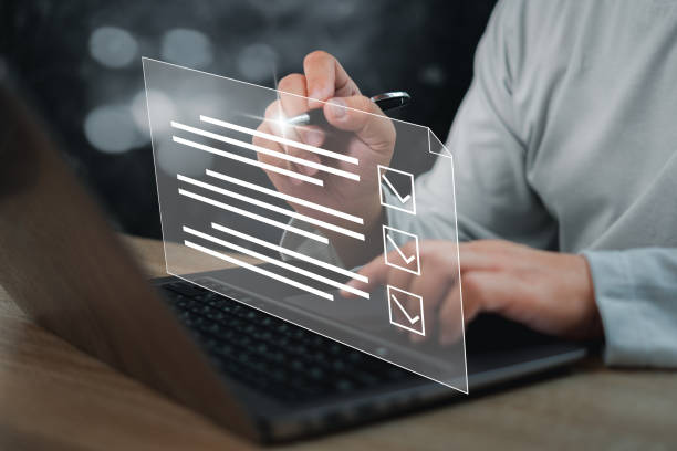 istock Businessman smart checklist and signs electronic on digital documents concept, Businessman use a pen signs on virtual screen documents with laptop on table 1422722710