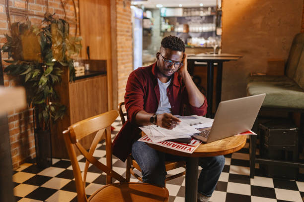 istock Tired owner sitting in the closed cafe 1422725998