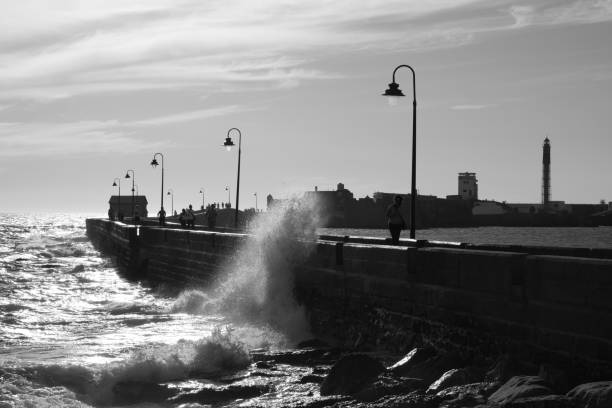 istock Sea breaking over port breakwater 1422729235