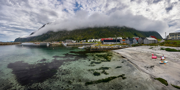 The inner harbor and small beach at Alnes with Godøy mountain in the background