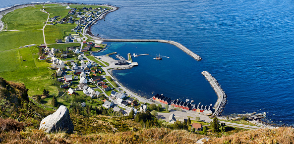 View from atop Godøy mountain overlooking Alnes harbor during a warm summer's day