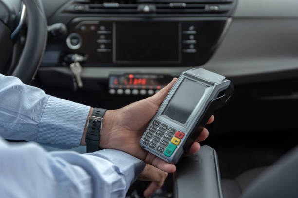 istock unrecognizable cab driver holding a bank payment terminal to process credit card payment purchases - transport concept, cab, taxi and technology 1422729857