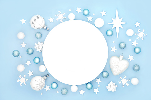 Christmas dinner plate table place setting with frosted decorations. Abstract design for Xmas festive holiday season and New Year. On pastel blue baclground.