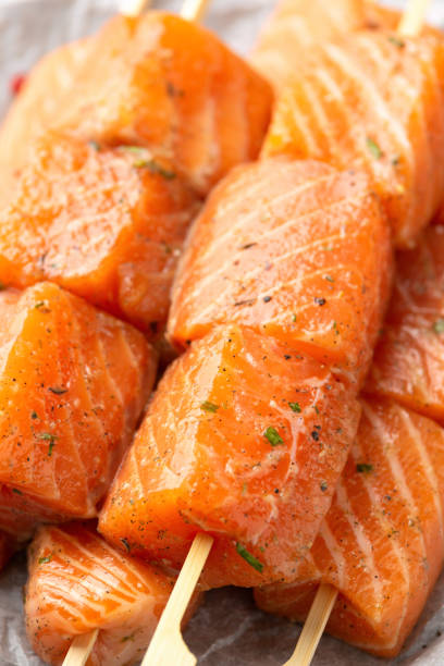 istock Fresh raw salmon skewers with herbs and ready to cook 1422734037